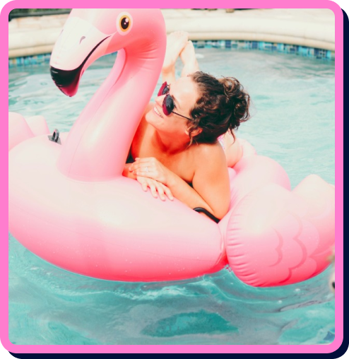 a woman on a pink flamingo float in a pool